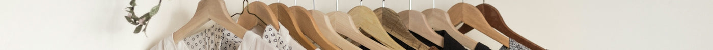 assorted clothes in wooden hangers