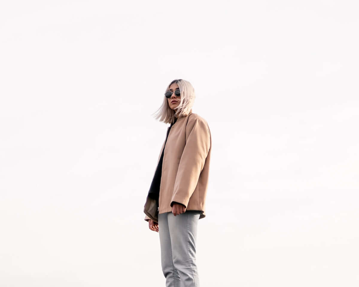 a woman with white hair standing on a skateboard