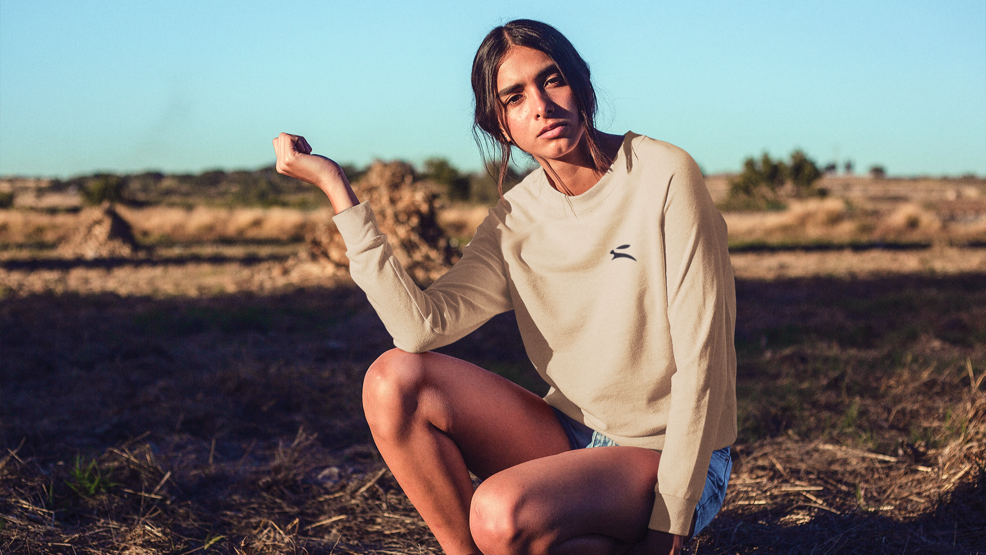 Original Grozavu bunny logo over Barcelona studio scene—premium cotton pieces and eco packaging