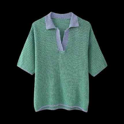 Green knit short-sleeve top with a blue collar and V-neck design displayed on a black background.