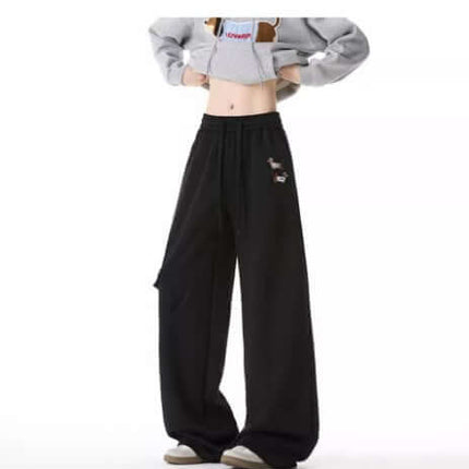 Embroidered Dog Sweatpants – Loose Fit worn by model, showcasing retro streetwear style and playful dog embroidery details.