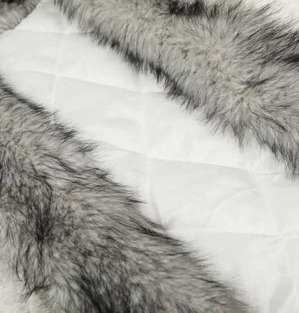 Detail of the soft, plush fur trim on a velvet hooded jacket, highlighting the luxurious texture and design.