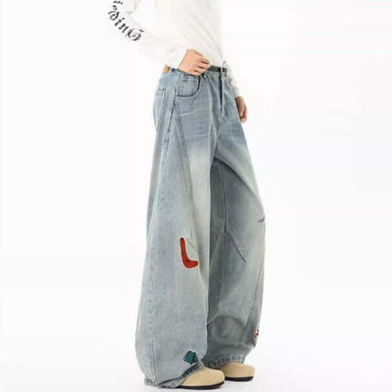 Embroidered Patchwork Denim Pants displayed on a model, featuring a loose fit and playful urban style.