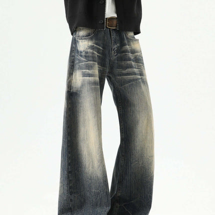 Knife-Edge Denim Trousers – Loose Fit on model showcasing a relaxed fit with distressed details in a fashionable pose.