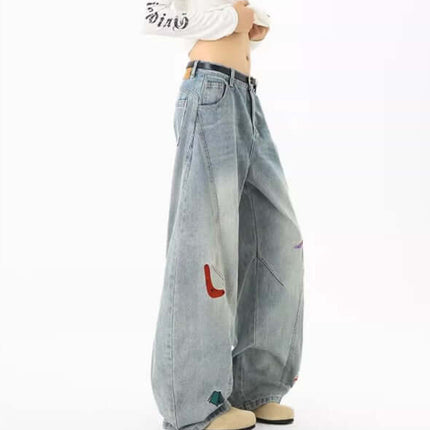 Embroidered Patchwork Denim Pants featuring playful designs and a loose fit for casual streetwear outfits.