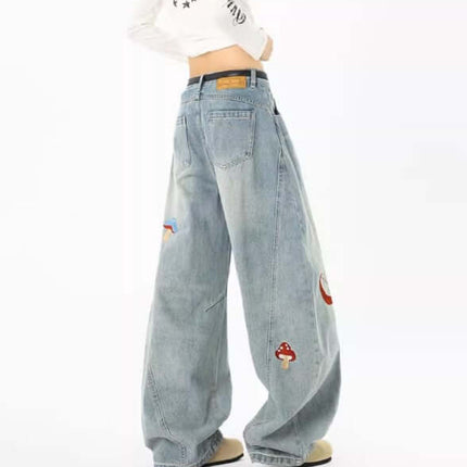 A model wearing Embroidered Patchwork Denim Pants showcasing a playful urban style with embroidery details and a loose fit.