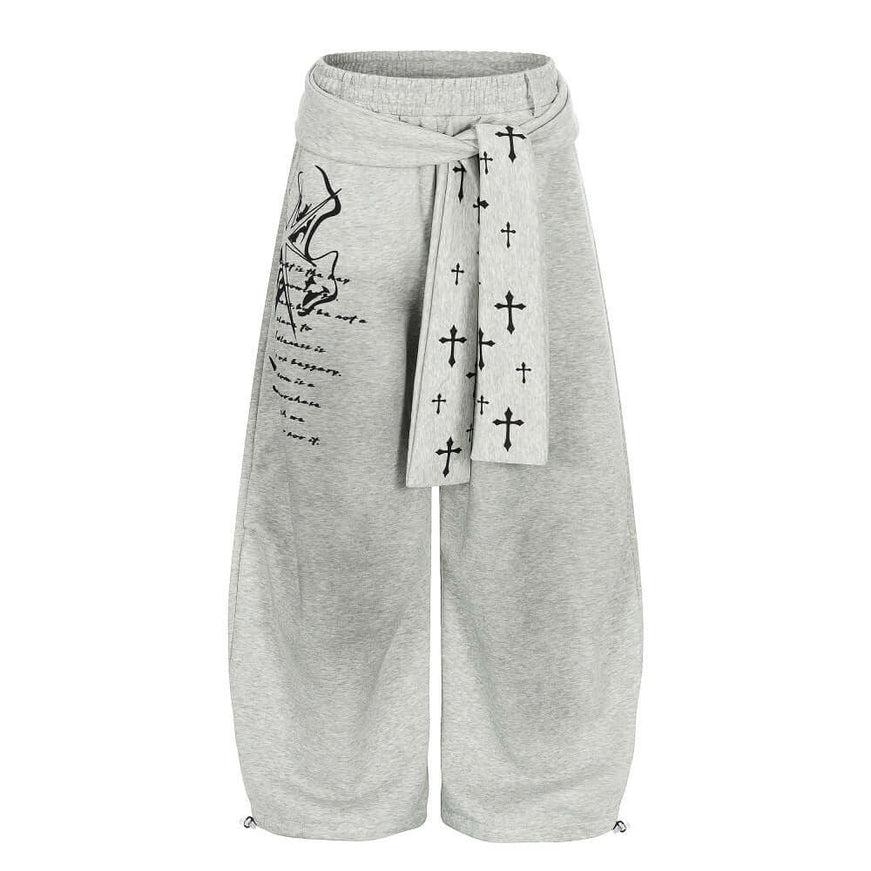 Model wearing Black graffiti cross dirty curved sweatpants by Grozavu
