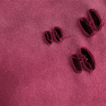 Close-up of fabric with distressed details, showcasing the texture and worn-in style of the Half-Zip Printed Hoodie – Loose Fit.