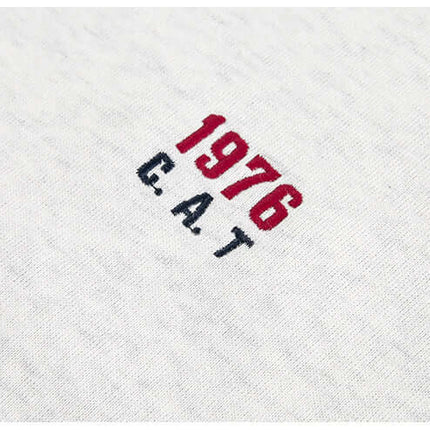 Image of the embroidered design on a shirt featuring the year 1976 and the letters C.A.T.
