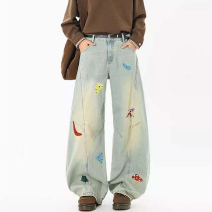 Embroidered Patchwork Denim Pants with colorful designs and relaxed fit for stylish streetwear.