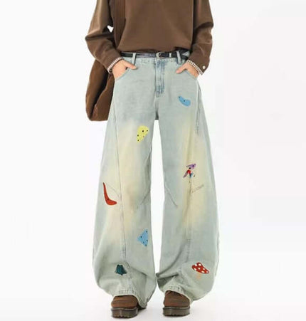 Embroidered Patchwork Denim Pants with colorful designs and relaxed fit for stylish streetwear.