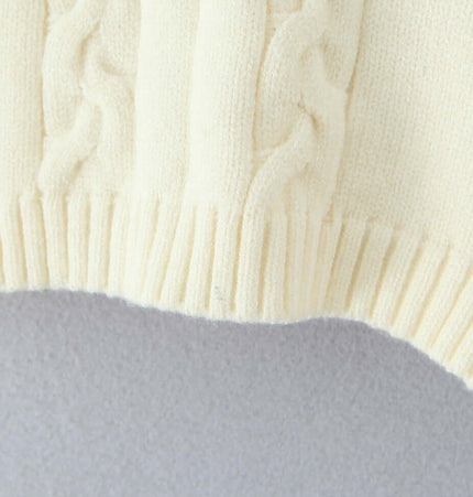 Close-up of the textured fabric and ribbed hem of the Off-Shoulder Twists Slim Knit Sweater in cream color.