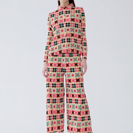 Woman wearing a relaxed fit organic cotton two-piece set with a vibrant multicolored plaid cardigan and matching pants.