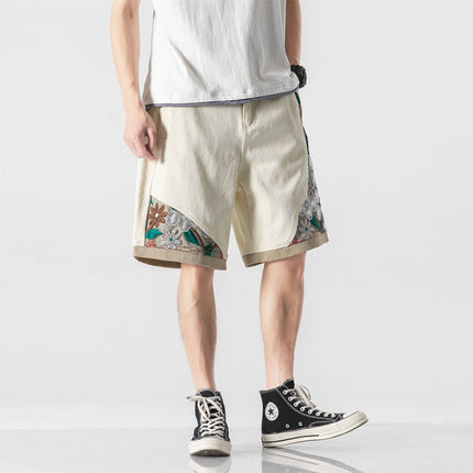 Trendy men's loose-fit cotton shorts with embroidered details, mid-length, organic and relaxed style, suitable for sports.