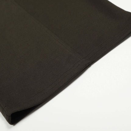 Close-up of the hem detailing of Solid Knife Pants - Loose Fit in dark color, showcasing soft fabric texture.