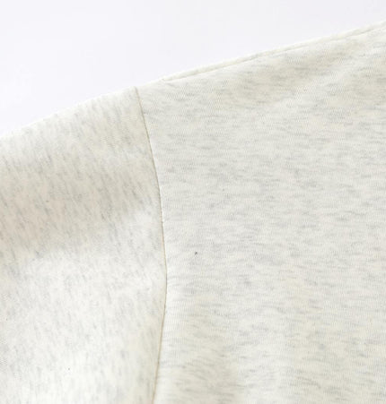 Close-up of the slanted shoulder design of the Slanted Shoulder Retro Graffiti Hoodie.