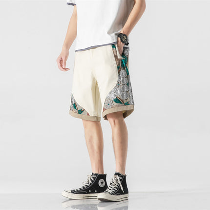 Man wearing trendy men's street style embroidered work shorts in organic cotton, showcasing a relaxed fit with straight leg and detailed embroidery.