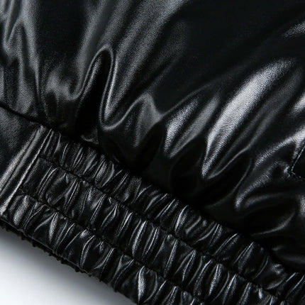 Detail of the oversized reversible hooded parka showcasing its sleek black faux leather material and elasticized hem.