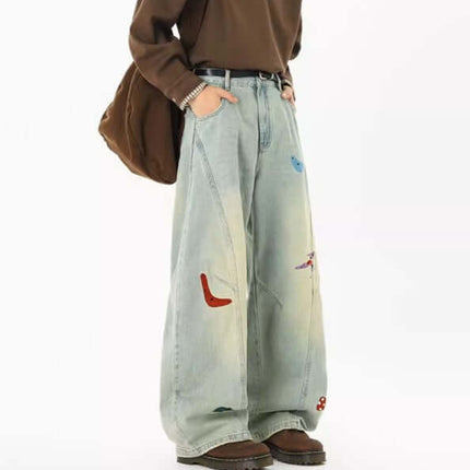 Knife-Cut Embroidered Pants – Loose Fit showcased in a relaxed, unique style with deconstructed denim and embroidery accents.