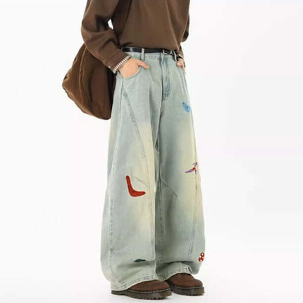 Embroidered Patchwork Denim Pants featuring playful embroidery and a loose fit for trendy streetwear style.