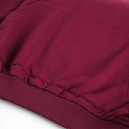 Half-Zip Printed Hoodie – Loose Fit close-up of pocket and hem detail in deep burgundy fabric.
