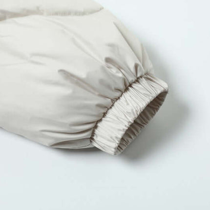 Close-up of sleeve detail on Wave Design Puffer Coat – Loose Fit in beige, showcasing elastic cuff for comfort and style.