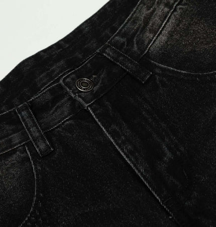 Washed Black Vintage Knife Cut Jeans close-up showing dark denim fabric and button detail.