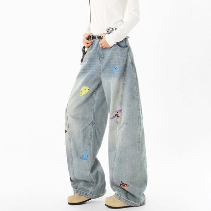 Embroidered Patchwork Denim Pants shown on model, featuring colorful embroidery and a relaxed fit design.
