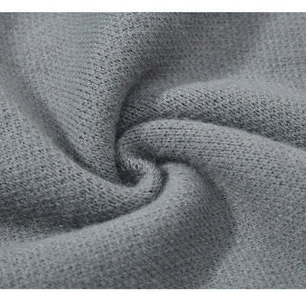 Close-up of soft gray knit fabric, highlighting texture of the Fringe Patchwork Knit Sweater – Loose Fit.
