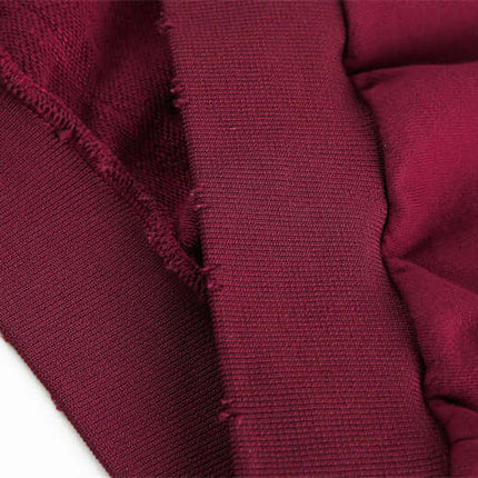 Close-up of the fabric and stitching details of a Half-Zip Printed Hoodie – Loose Fit in a deep burgundy color.