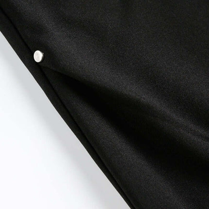 Close-up of the fabric texture of Wide Leg Pleated Plaid Trousers showcasing the design and button detail.