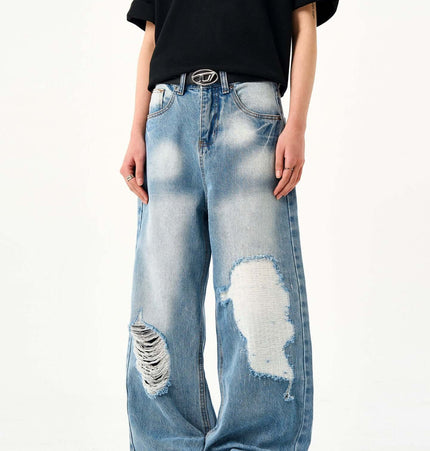 Casual Ripped Light Blue Jeans – Loose Fit worn by a model, showcasing vintage washed finish and ripped details.