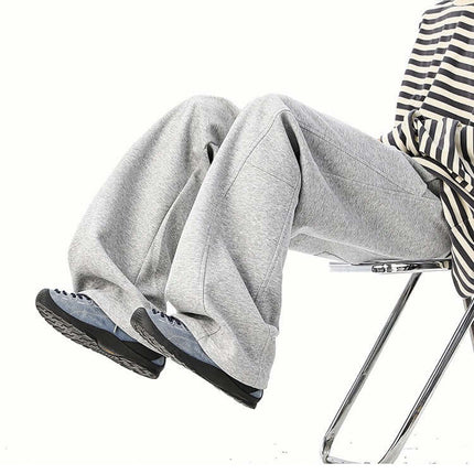 Heavyweight Wide-Leg Pants - Loose Fit on a model sitting, showcasing the casual and comfortable style.