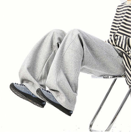 Heavyweight Wide-Leg Pants - Loose Fit on a model sitting, showcasing the casual and comfortable style.