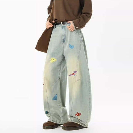 Embroidered Patchwork Denim Pants showcasing playful urban style with a relaxed fit and colorful patchwork details.