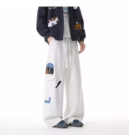 Dog Embroidered Sweatpants - Loose Fit worn with a navy jacket, showcasing playful vintage embroidery and a relaxed look.
