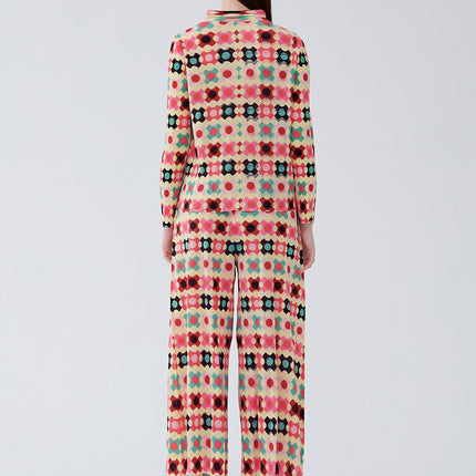 Rear view of a woman wearing a plaid cardigan and pants two-piece set in vibrant colors, embracing a relaxed and organic cotton style.