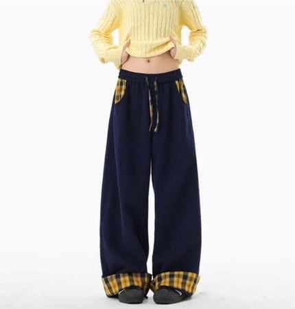 Loose Wide-Leg Sweatpants worn with a yellow sweater, featuring a relaxed fit and stylish plaid pockets.
