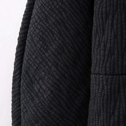 Close-up of the textured fabric on the Fur Cuff Single Breasted Jacket showcasing its elegant black design.