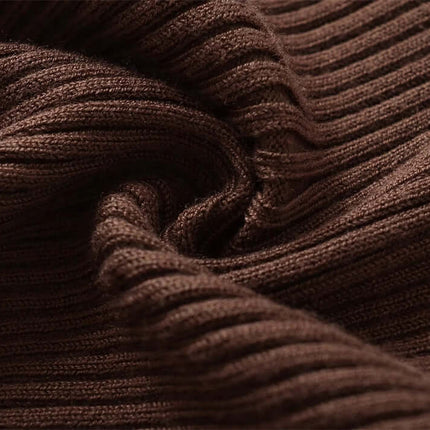 Close-up of soft, brown ribbed fabric showcasing the texture of the Metal Knot Hollow-Out Flare Sleeve Knit Top.