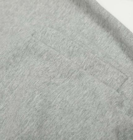Close-up of the fabric and pocket detail of the Washed Retro Zip Hooded Jacket – Fitted in gray.
