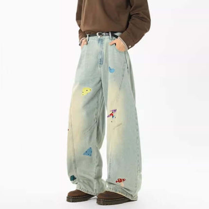 Embroidered Patchwork Denim Pants showcasing playful urban style with distinct patchwork designs and a relaxed fit.
