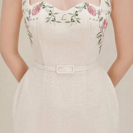 Chic hip-hugging dress with organic relaxed cotton, embroidered floral straps, and elegant off-white hue. Perfect for a stylish and comfortable look.