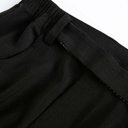 Close-up of the waistband of Wide Leg Pleated Plaid Trousers, highlighting the mid-waist drawstring closure design.