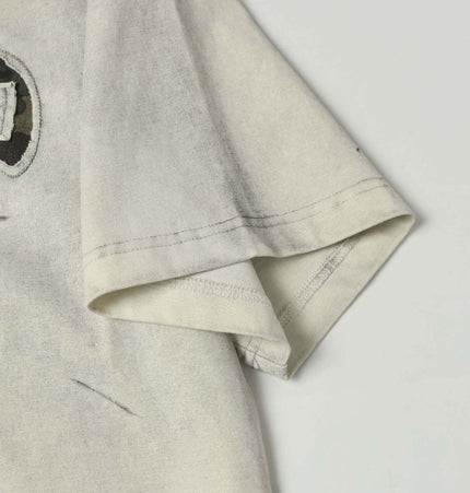 Washed Patchwork Letter TShirt – Loose Fit showing the half-length sleeve and embroidered detail.