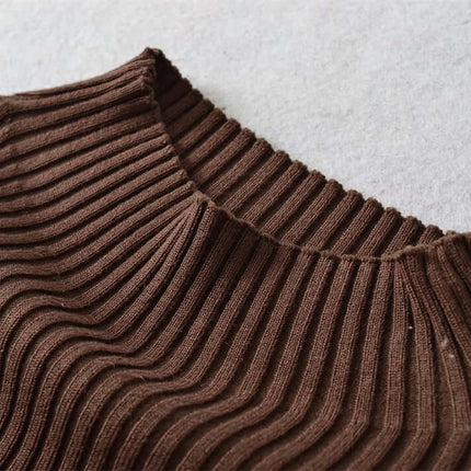 Close-up view of the neckline of the Metal Knot Hollow-Out Flare Sleeve Knit Top in brown ribbed fabric.
