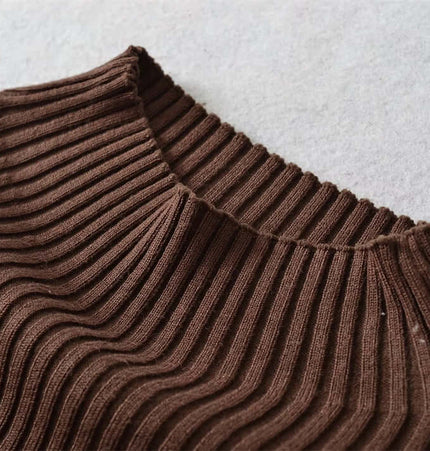 Close-up view of the neckline of the Metal Knot Hollow-Out Flare Sleeve Knit Top in brown ribbed fabric.