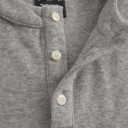 Close-up of the Stand Collar Button Hoodie – Loose Fit showcasing button detailing and soft gray fabric.
