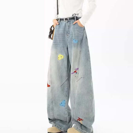 Embroidered Patchwork Denim Pants worn by a model showcasing their playful and urban style with patchwork details.