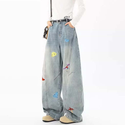 Knife-Cut Embroidered Pants – Loose Fit showcasing a relaxed silhouette with colorful embroidery on denim.
